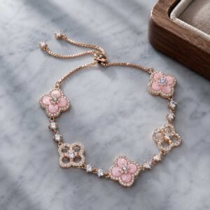 Close-up of a handcrafted classic clover bracelet made of highly polished gold-toned resonance alloy link chain, 24h sound-bath calibrated at 528Hz, displayed elegantly inside the white Luxe Abundance Box.