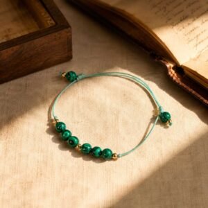 Close-up of a handcrafted vintage style lucky brand turquoise bracelet with natural blue-green beads set in detailed retro scrollwork metal frames, pre-calibrated at 528Hz, displayed inside the signature white Luxe Abundance Box.