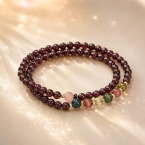 Handcrafted premium natural red garnet wrap bracelet with multiple crimson stone strands, 24h sound-bath calibrated at 528Hz for 2026 emotional balance, showcased inside the signature white Luxe Abundance Box.