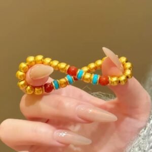 Gold bead manifestation bracelet for 2026 luck in an infinity loop shape