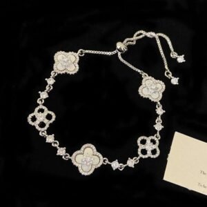 Detailed view of silver lucky clover bracelet with white mother of pearl style charms and bolo clasp