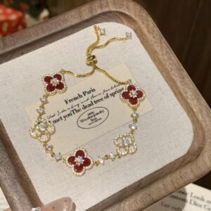 Elegant 18K gold bracelet with red four leaf clover charms and sparkling zircons