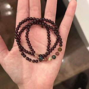 Natural garnet wrap bracelet with multi-color healing stones on a hand