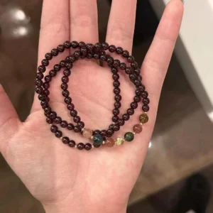 Home 6 Natural garnet wrap bracelet with multi-color healing stones on a hand