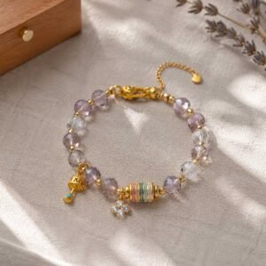 Close-up of a premium handcrafted amethyst botanical flower bracelet featuring intricately carved violet stones, 24h sound-bath calibrated at 528Hz for 2026 emotional balance, nested inside the signature white Luxe Abundance Box.